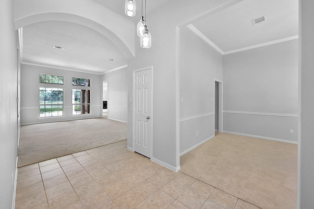 hall with crown molding and light colored carpet