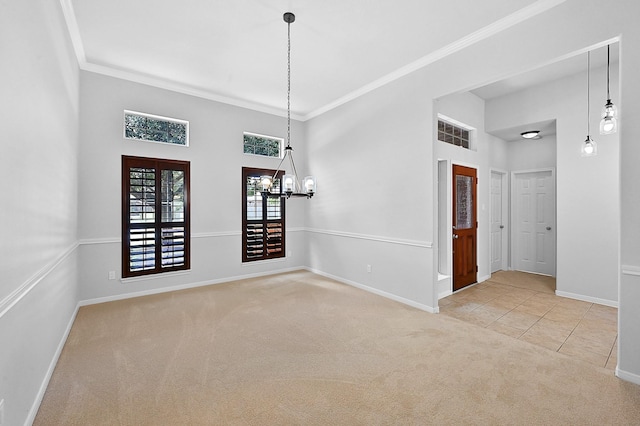 carpeted spare room featuring crown molding, a towering ceiling, and an inviting chandelier