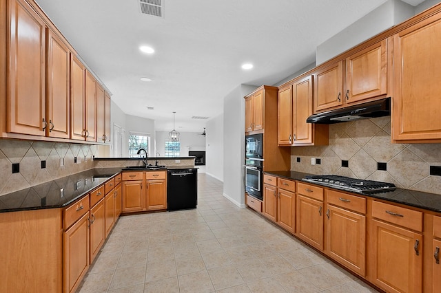 kitchen with sink, hanging light fixtures, kitchen peninsula, dark stone counters, and black appliances