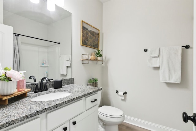 bathroom with walk in shower, vanity, toilet, and hardwood / wood-style floors