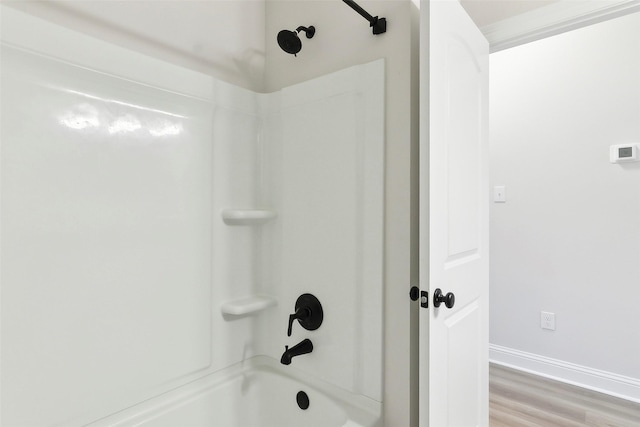 bathroom with wood-type flooring and shower / bathing tub combination