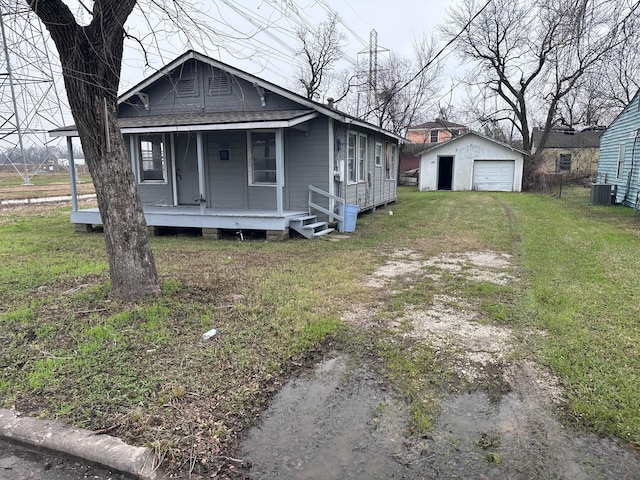 bungalow-style home with an outbuilding, a garage, a front lawn, and a porch