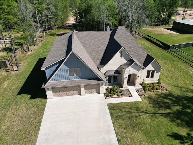 view of front of home featuring a garage and a front lawn