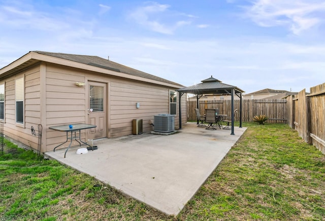 rear view of house with a gazebo, a yard, a patio, and central air condition unit