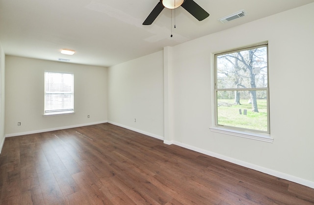 empty room featuring dark hardwood / wood-style flooring and ceiling fan