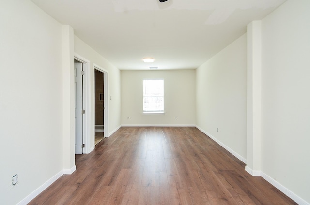 unfurnished room featuring dark hardwood / wood-style floors