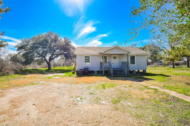 view of front of home with a porch and a front lawn