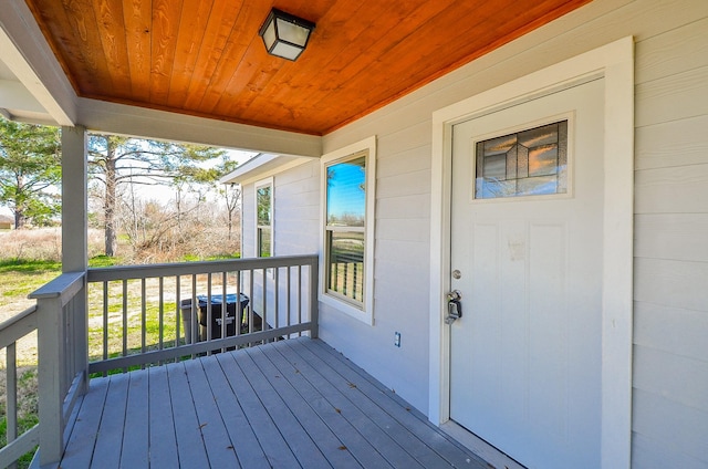 wooden terrace featuring covered porch