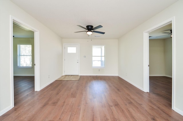 interior space with plenty of natural light, ceiling fan, and light wood-type flooring