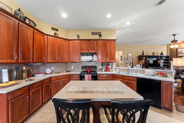 kitchen featuring a kitchen island, black appliances, sink, decorative backsplash, and kitchen peninsula