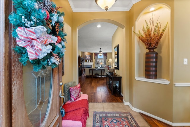 hall with crown molding and tile patterned floors