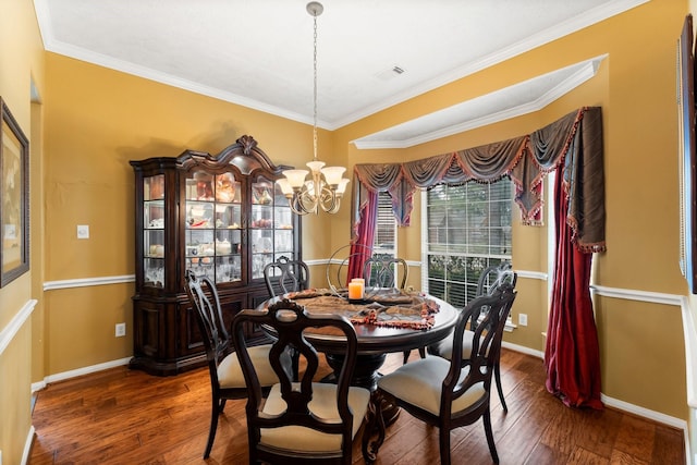 dining area with crown molding, dark hardwood / wood-style floors, and a notable chandelier