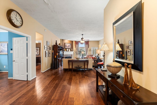 corridor featuring dark wood-type flooring and a textured ceiling