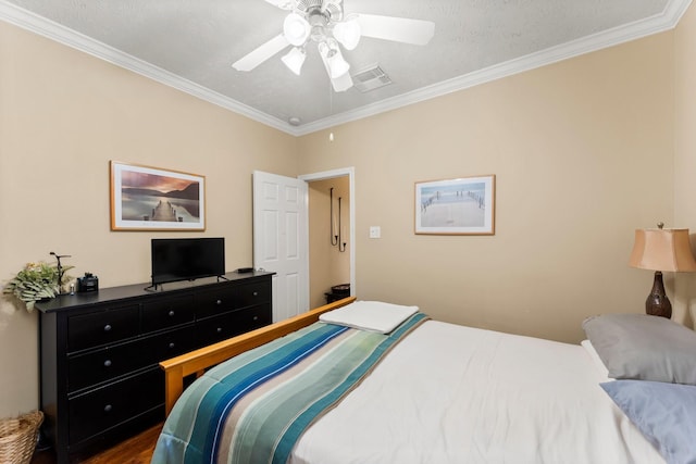 bedroom with hardwood / wood-style flooring, ornamental molding, and ceiling fan