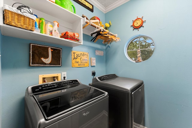 laundry area featuring ornamental molding and washer and dryer