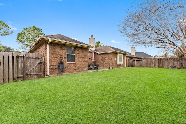 rear view of property with a lawn and a patio area