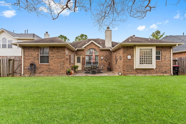 rear view of house featuring a patio area and a lawn