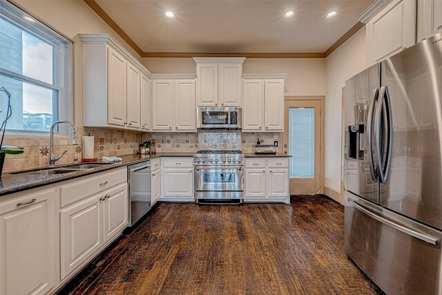 kitchen with white cabinetry, sink, ornamental molding, and stainless steel appliances