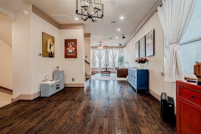 hallway featuring ornamental molding and an inviting chandelier