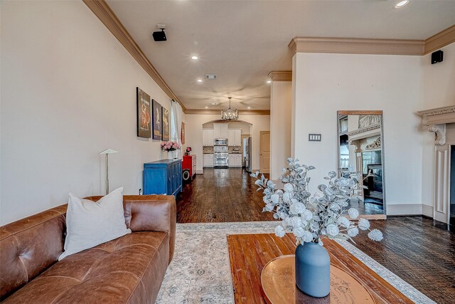 living room with crown molding and dark wood-type flooring