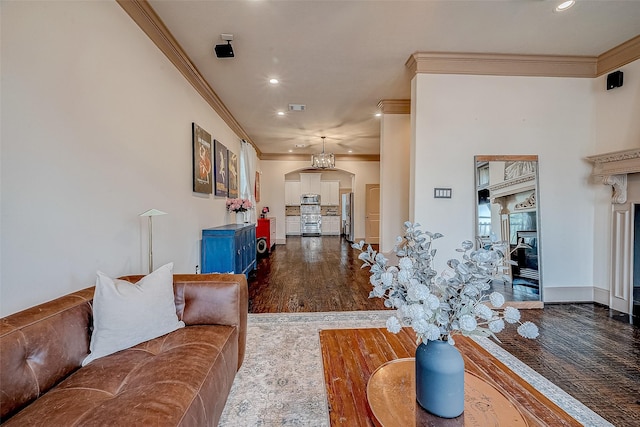 living room with dark wood-type flooring and ornamental molding