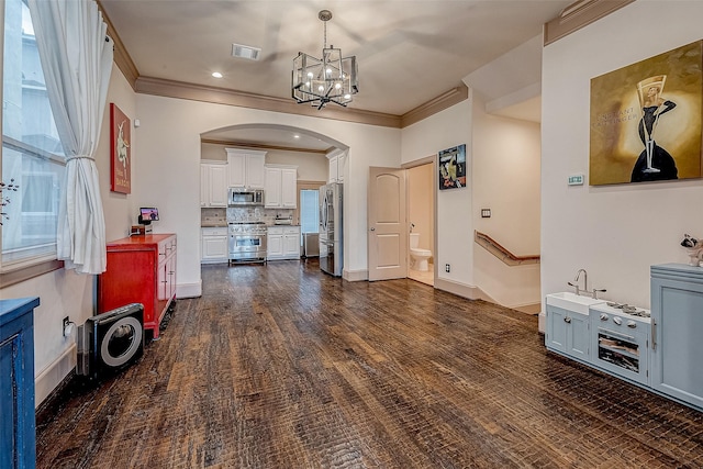 living room featuring ornamental molding, dark wood-type flooring, and a chandelier