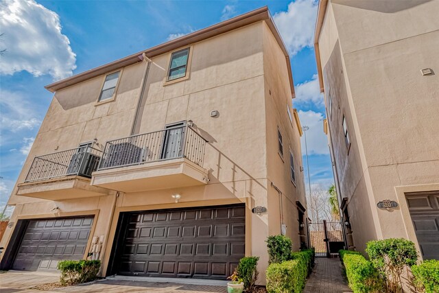 view of front facade with a balcony and a garage