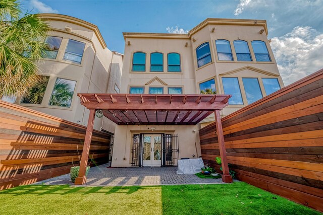 rear view of property with a patio, a pergola, and french doors