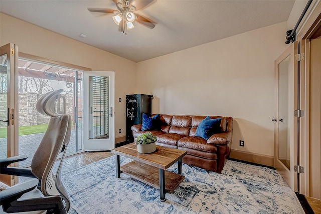 living room featuring hardwood / wood-style flooring, lofted ceiling, and ceiling fan