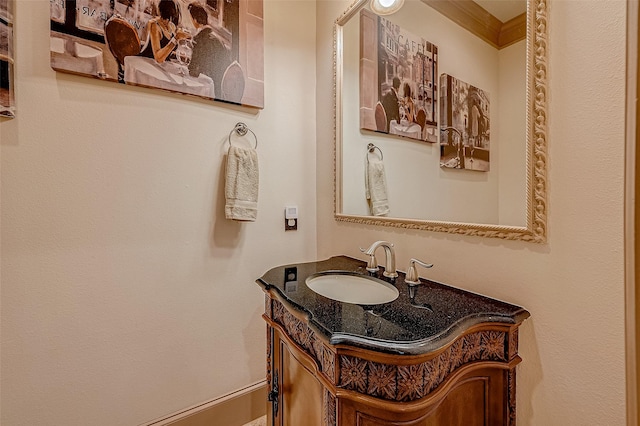 bathroom with vanity and ornamental molding