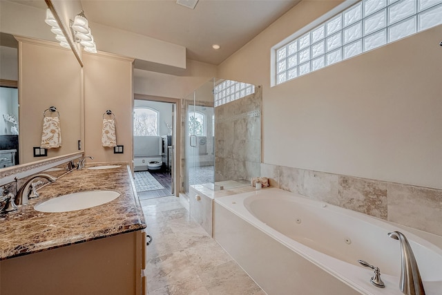 bathroom with independent shower and bath and vanity