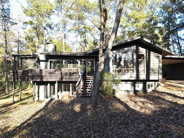 back of house with a wooden deck