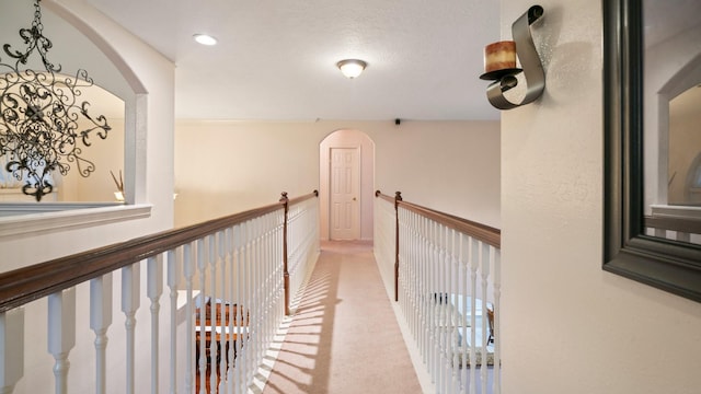 corridor with light carpet, an upstairs landing, and recessed lighting