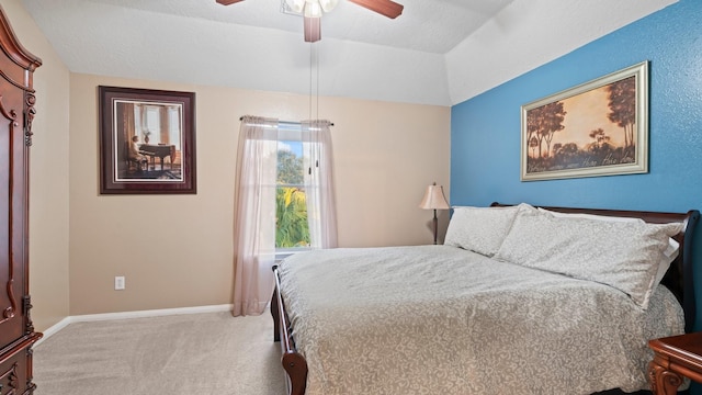 bedroom featuring light carpet, a textured ceiling, vaulted ceiling, and ceiling fan