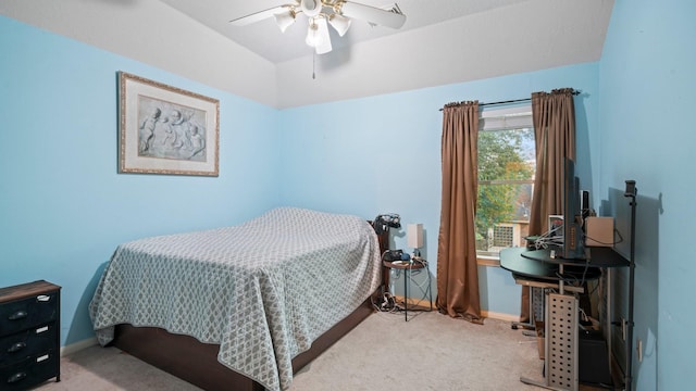 bedroom featuring vaulted ceiling, light colored carpet, and ceiling fan