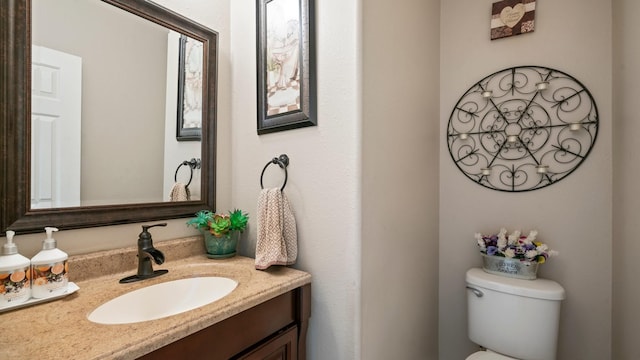 bathroom featuring toilet and vanity