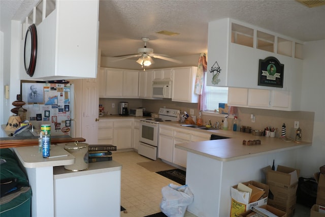 kitchen featuring sink, white appliances, ceiling fan, white cabinetry, and kitchen peninsula