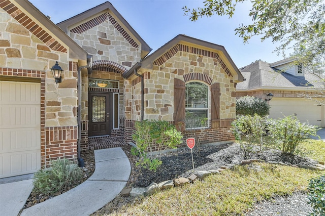 doorway to property with a garage