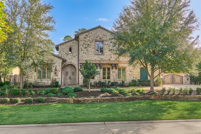 2 Berkley Hall Ct, The Woodlands, TX 77389 - view of front of home featuring stone siding and a gate