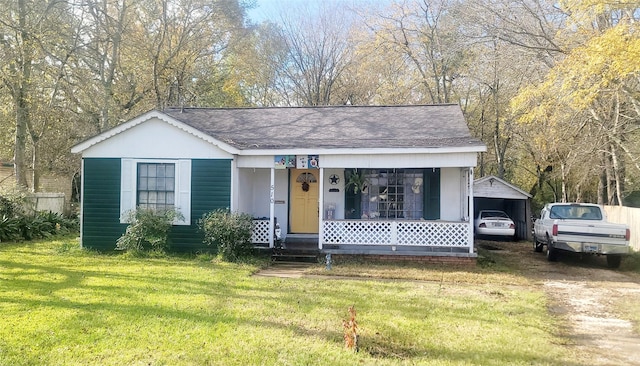 view of front of house with a front yard and a carport