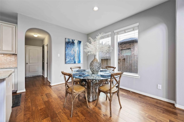 dining area featuring dark wood-type flooring