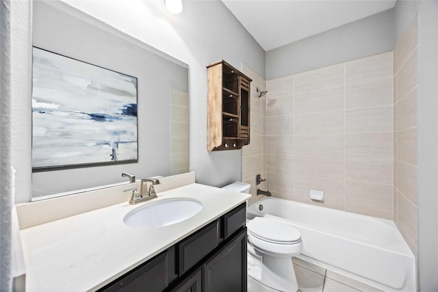 full bathroom with tiled shower / bath combo, vanity, tile patterned floors, and toilet