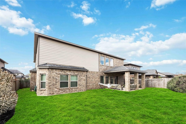 back of property featuring a yard and a patio