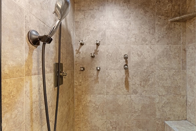 interior details with a tile shower