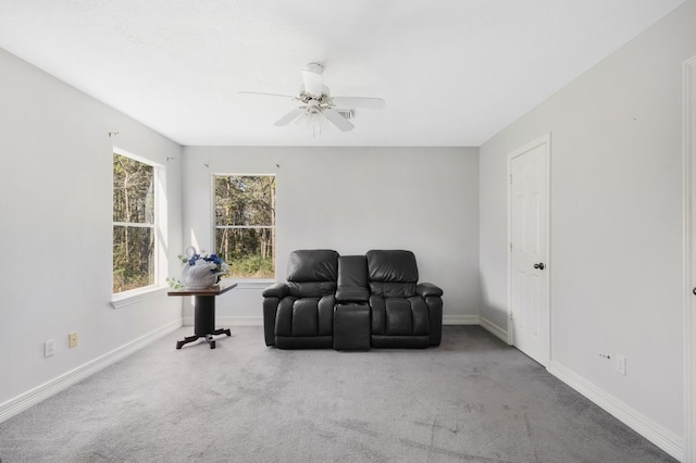 sitting room with carpet and ceiling fan