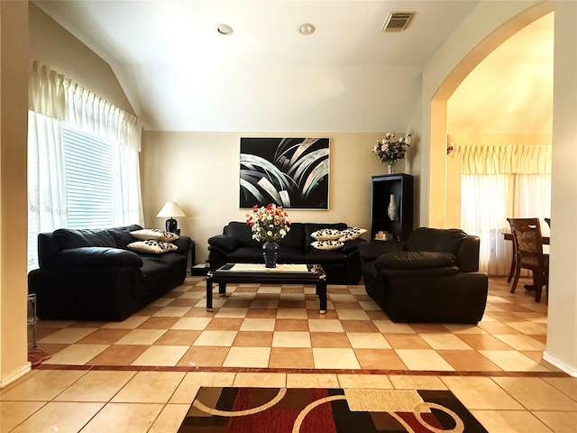 living room featuring lofted ceiling and light tile patterned floors