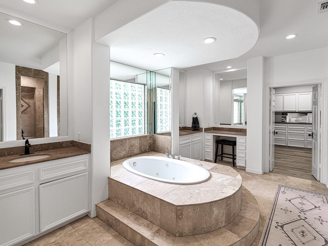 bathroom featuring vanity and shower with separate bathtub