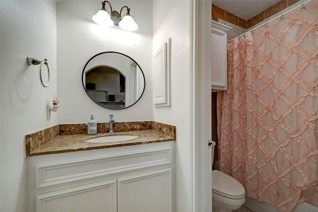 bathroom featuring vanity, a notable chandelier, and toilet