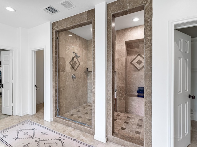 bathroom with a shower with door and tile patterned flooring