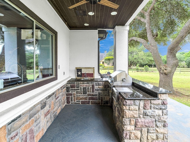 view of patio / terrace featuring an outdoor kitchen and ceiling fan